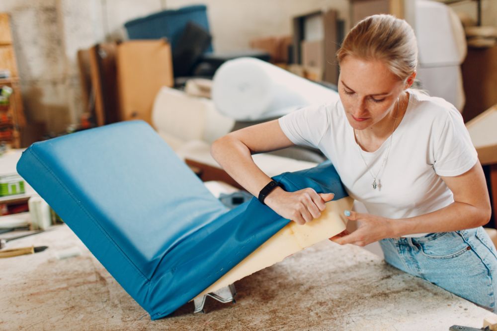 A woman is engaged in her work in a well-equipped workshop filled with tools and materials.