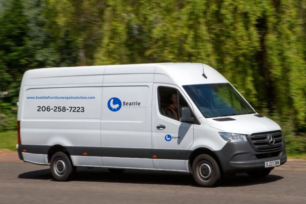 A white van traveling along a road surrounded by greenery.