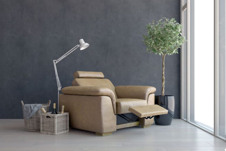 A cozy recliner positioned in front of a wall adorned with a green plant, creating a relaxing atmosphere.