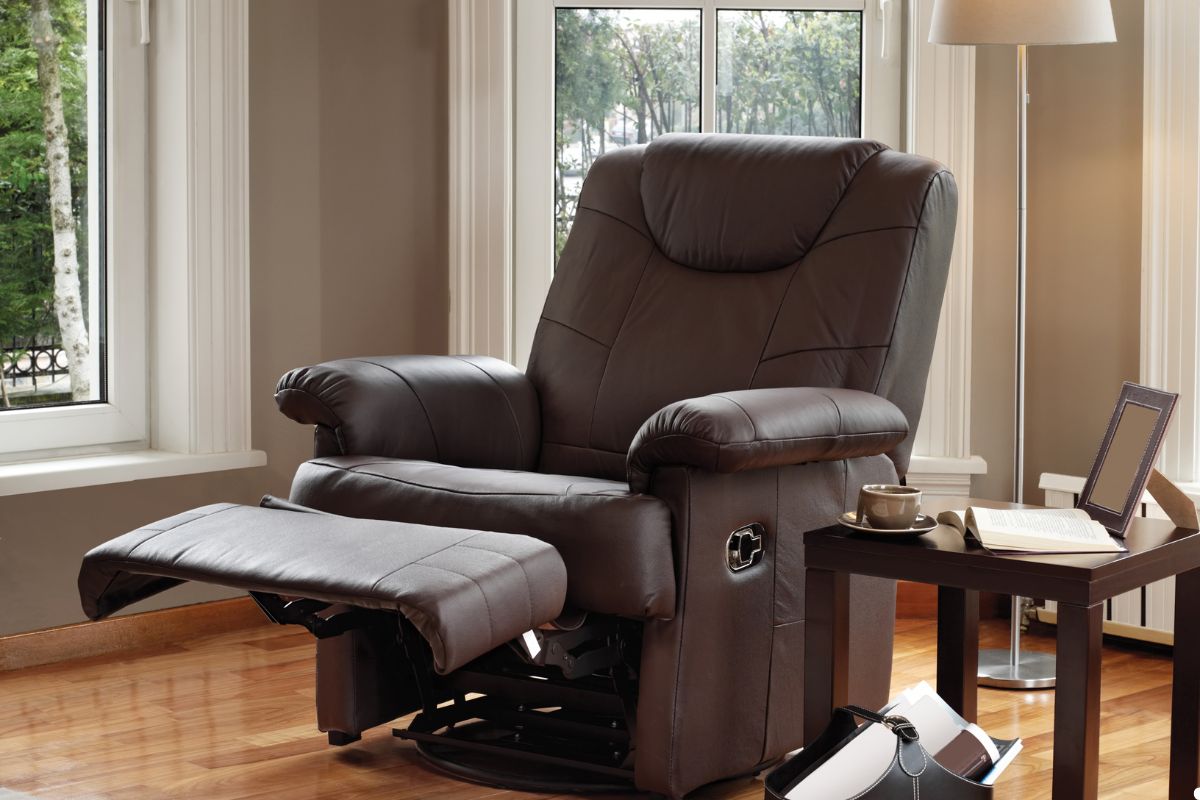 A cozy recliner chair positioned in a bright living room next to a large window, inviting relaxation and comfort. 