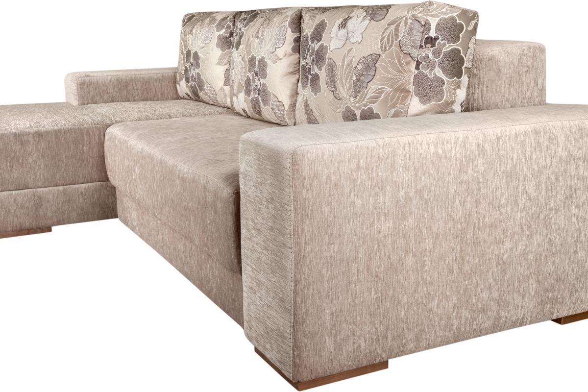 Beige sectional couch featuring a vibrant floral pattern, elegantly arranged in a cozy living room setting.
